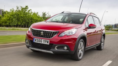 Red Peugeot 2008 driving along an open road